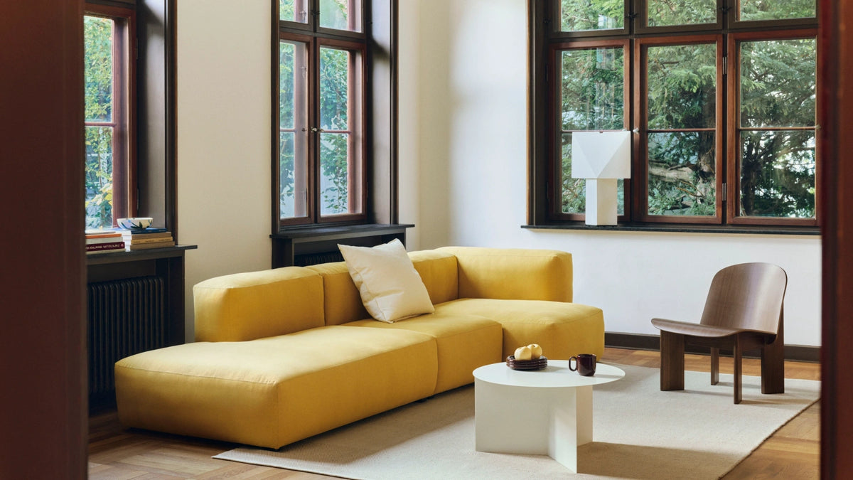Yellow HAY Mags Soft sofa in a living room with a low coffee table and lounge chair.
