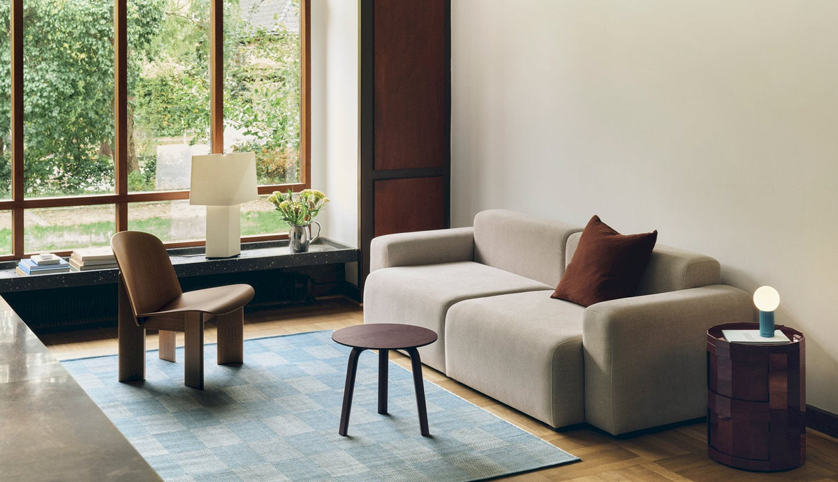 HAY Check Rug positioned beneath a sofa and living-room seating.