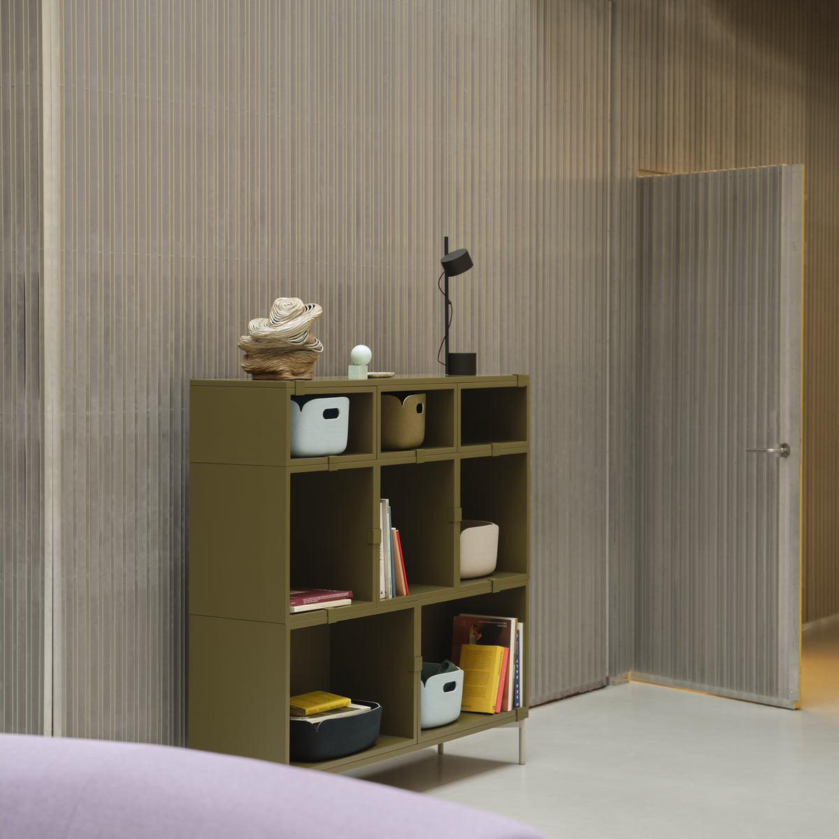 Muuto Post Table Lamp in black on a Stacked shelving unit beside a Connect sofa