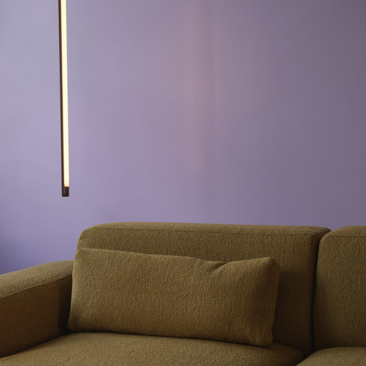 Muuto Fine Suspension Lamp 90 cm in deep red shown vertically beside a Connect Soft sofa; installation context