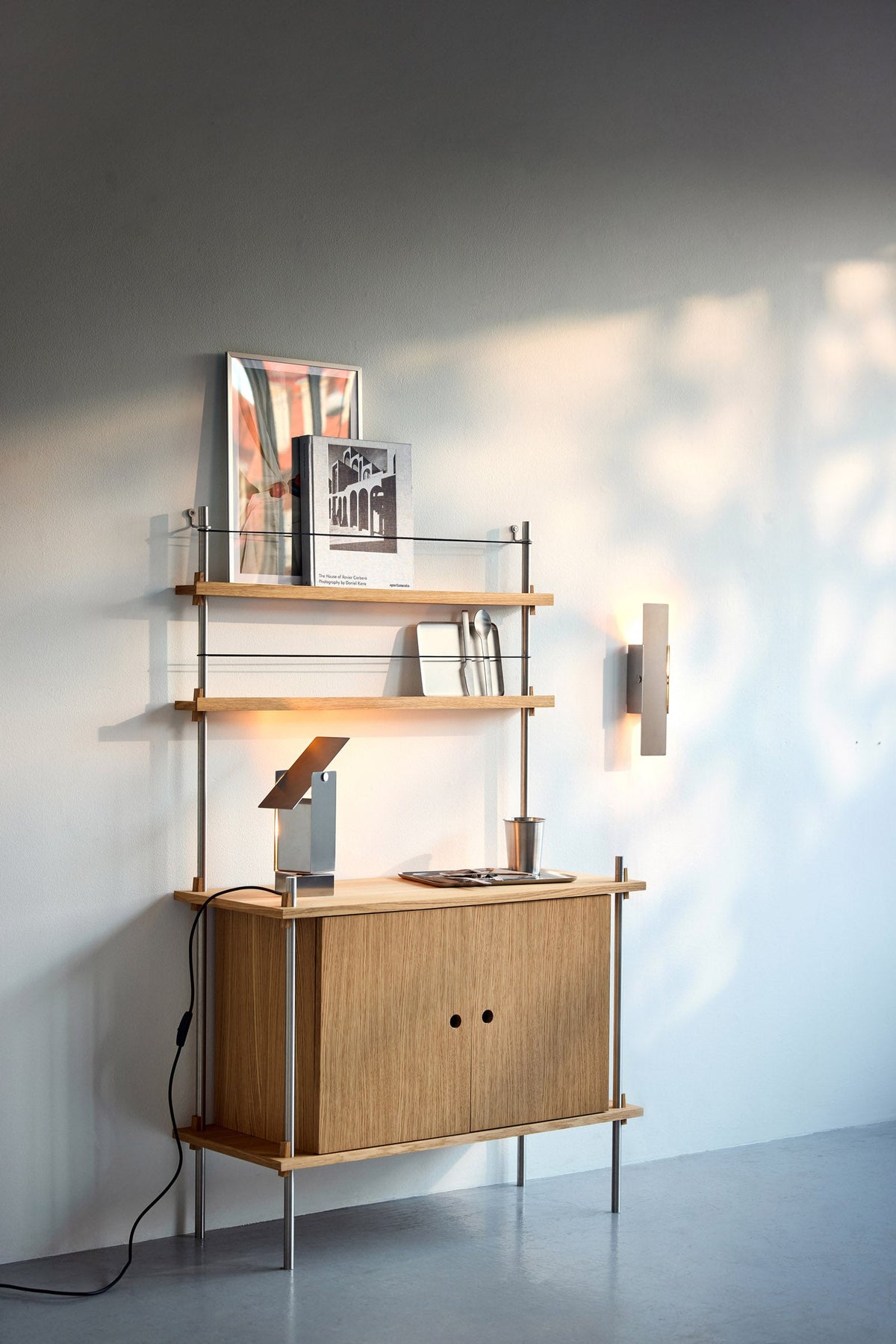 MOEBE shelving system with an oak cabinet, display shelves and lighting.
