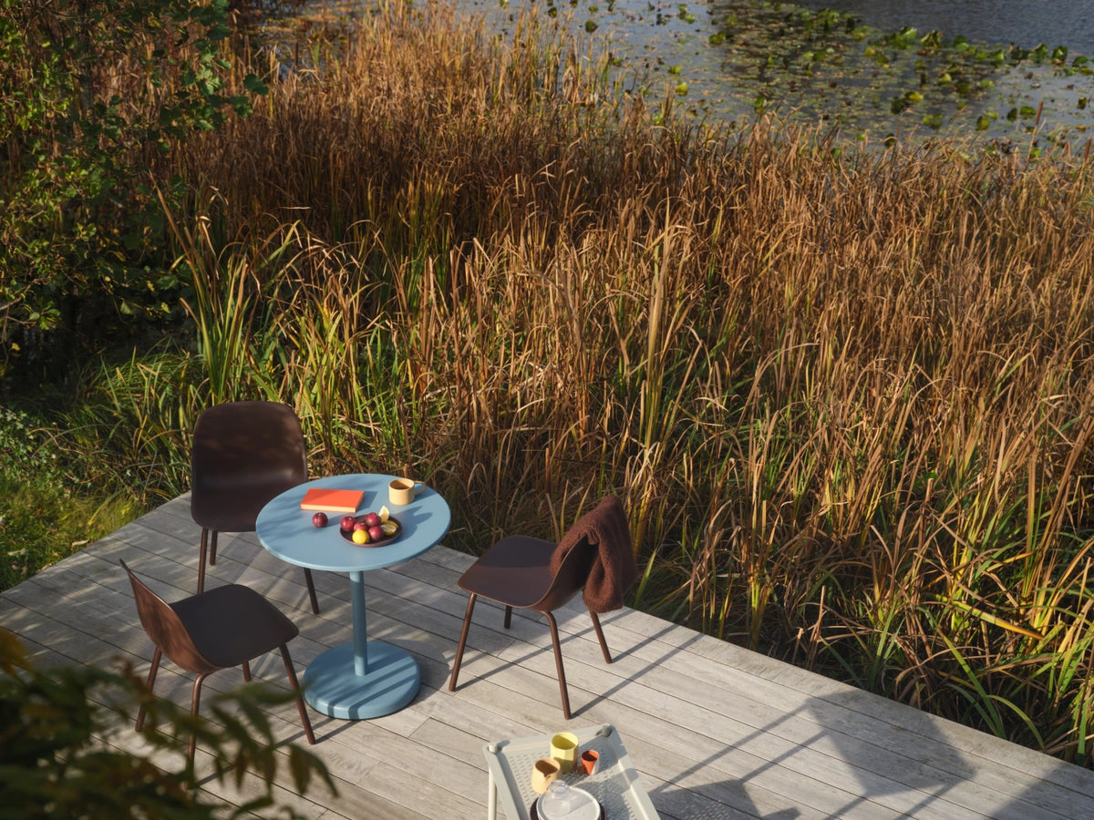 Muuto Fiber chairs with different shells and bases arranged around a table.