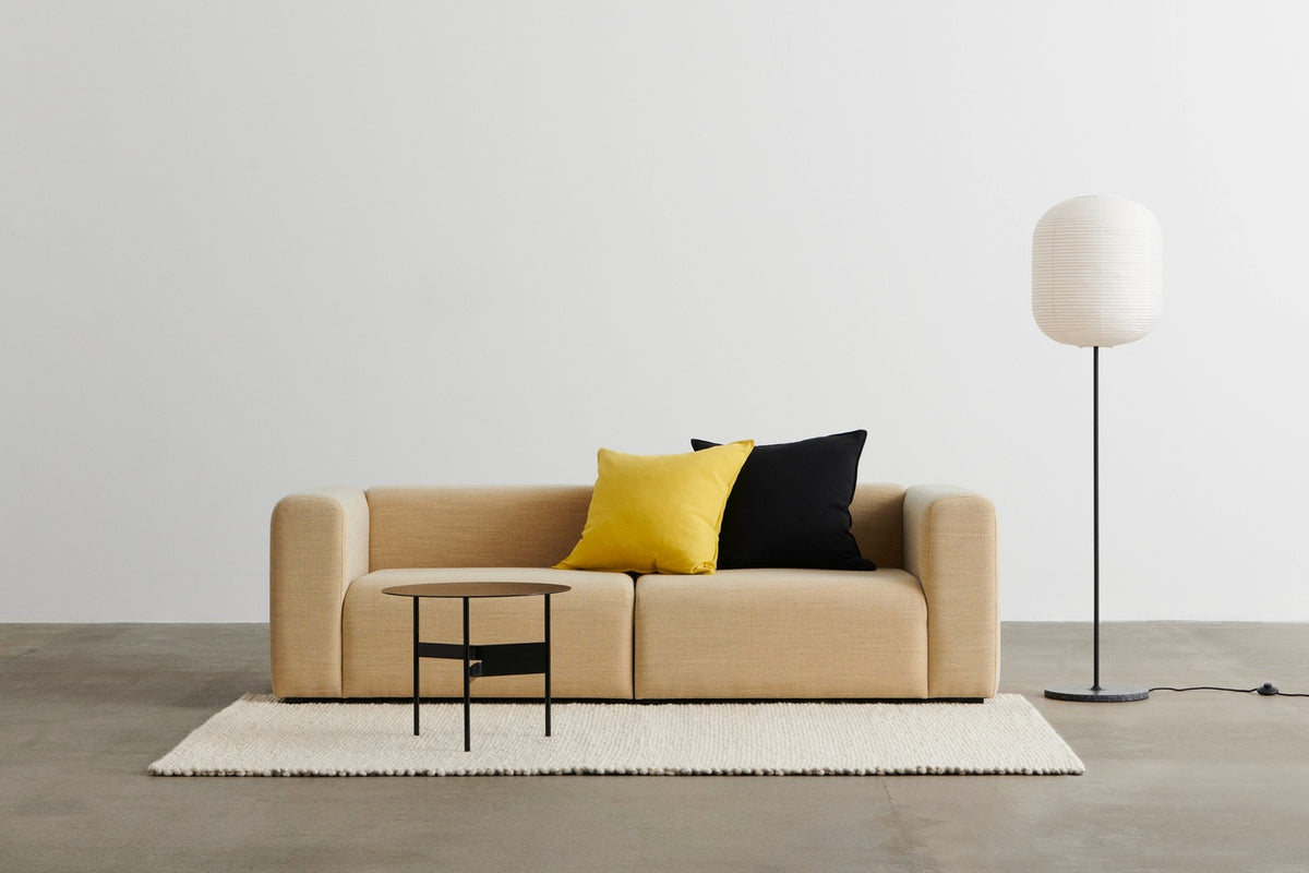 HAY sofa and floor lamp arranged together in a contemporary room.