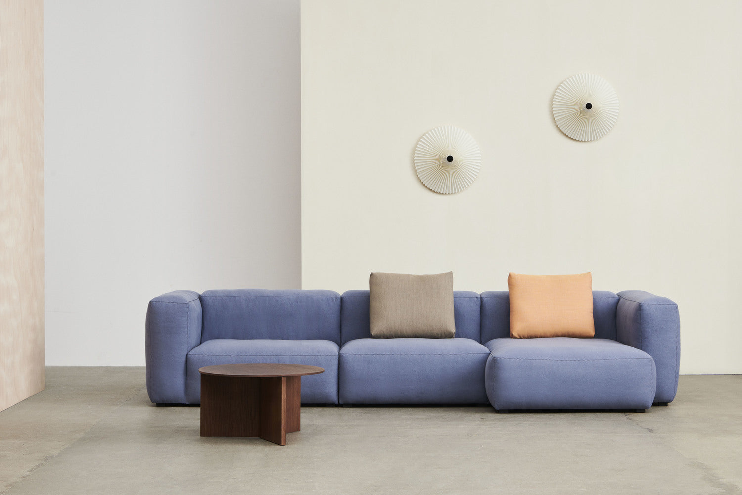 HAY sofa styled with cushions in varied colours and textures.
