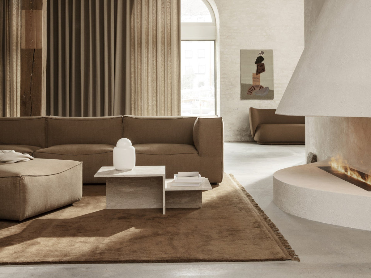 ferm Living Distinct travertine coffee table in a furnished interior