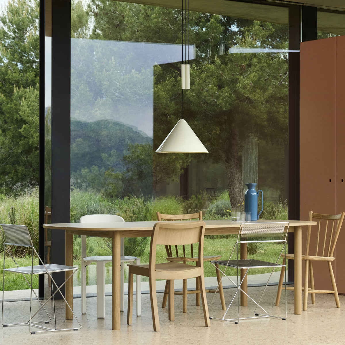HAY Compass Adjustable Pendant in oyster white above an oak Annex dining table
