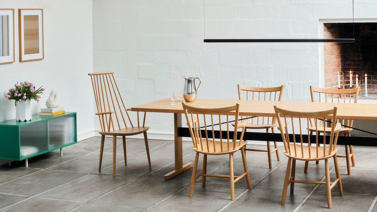 HAY Passerelle dining table and wooden J-Series chairs in a bright dining room