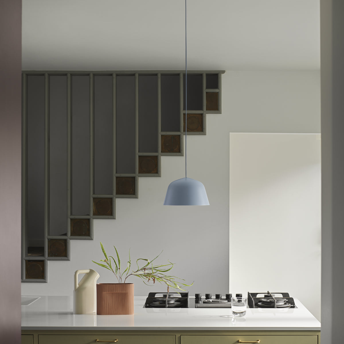 Muuto Ambit family context: a single 25 cm light blue pendant above a kitchen counter